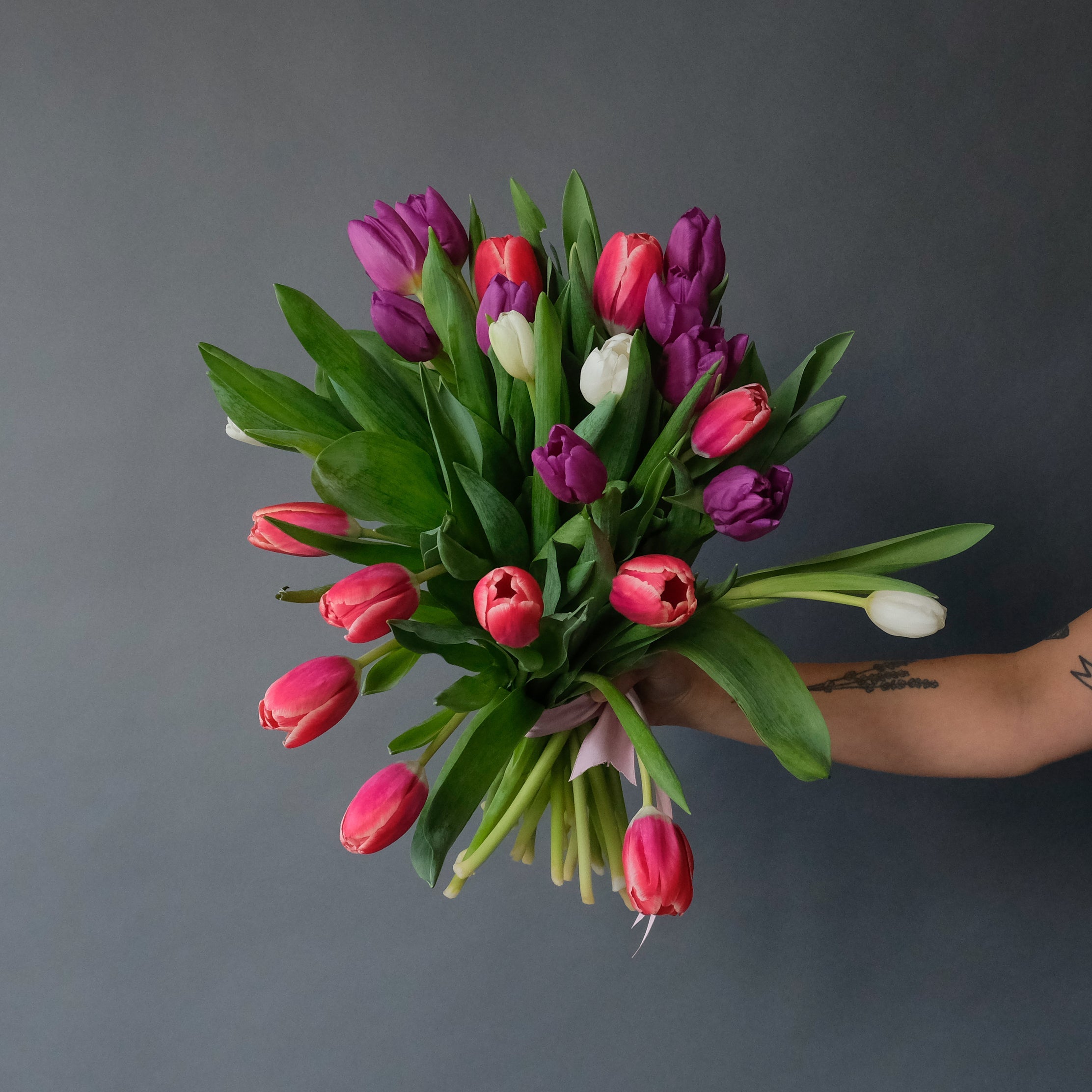 Two Dozen Tulips In Vase